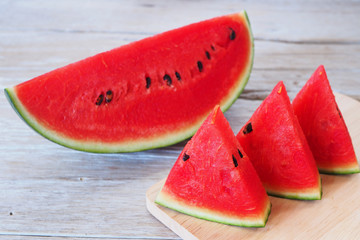 Close up of sliced watermelon on a wooden table.