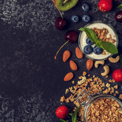 Tasty ingredients (granola, fruits, berries, yogurt and nuts) fo