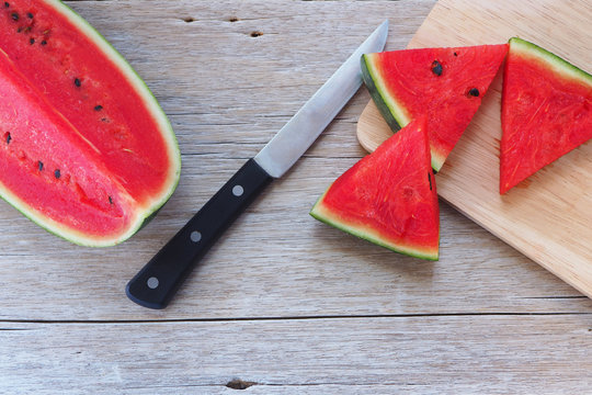 Top view of sliced watermelon on a wooden table.