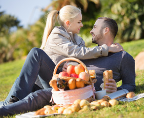 Loving happy  couple chatting as having picnic