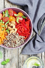 Quinoa bowl with raw vegetables and nuts. Superfoods and clean eating concept. Selective focus 