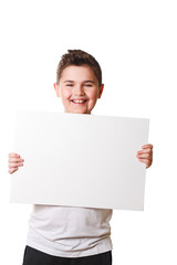 Funny little boy holding a large white plate for your text in th