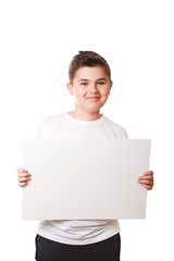 Funny little boy holding a large white plate for your text in th