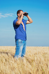 Handsome Young Man Looking through binoculars