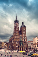 Fototapeta Church of St. Mary in the main Market Square in cloudy weather. Basilica Mariacka. Dramatic sky. Krakow. Poland. obraz