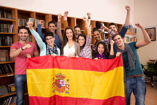 Team of excited Spanish students with victory smile