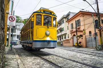 Zelfklevend Fotobehang Iconic bonde tram travels along the streets of the tourist nieghborhood of Santa Teresa in Rio de Janeiro, Brazil  © lazyllama