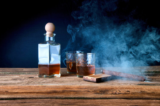 Whisky and cigar on wooden table