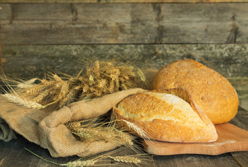 Bread with ears of wheat on a rough fabric