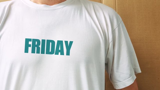 Guy wearing white t-shirt with days of the week printed on chest