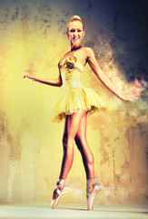 Beautiful ballerina in yellow tutu on point.  Image with a digit