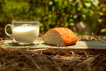 bread and milk cup on wooden board