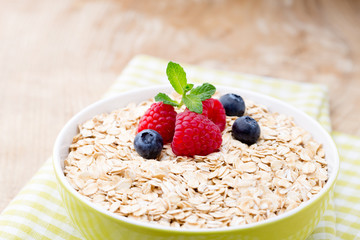Oatmeal porridge with berries. Raspberries and blueberries.