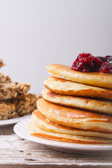 Stack of pancakes with glass of orange juice