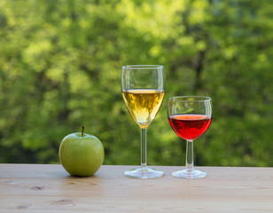 two wine glasses and apple on table 