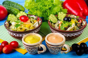 Salad with vegetables, olives and sauce.