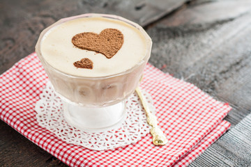 dessert tiramisu decorated with hearts on a red napkin and a gol © tanacha