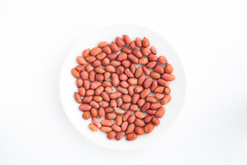 Crude peanuts on a plate white background