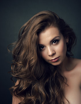 Portrait of a young beautiful brunette girl with long  hair