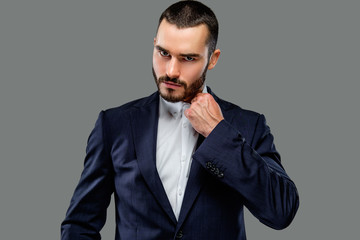 Portrait of bearded male in a suit.