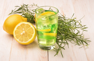 Glass of fresh homemade lemonade with tarragon and lemon