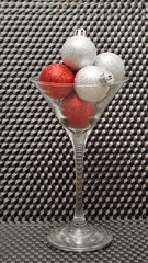 Red and silver Christmas tree baubles in a martini glass isolate