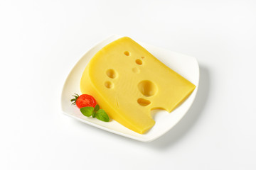 wedge of yellow cheese with eyes
