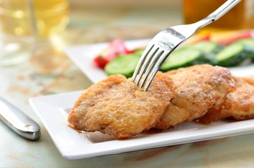 breaded chicken cutlets on a white plate