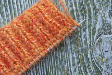 Fototapeta na wymiar Knitting orange mohair wool and needles