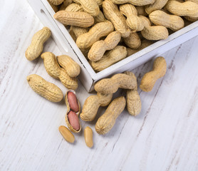 Peanuts on wooden background