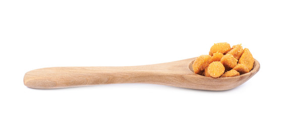 Spoon filled with the breaded peanuts