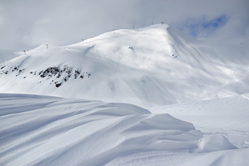 ski resort landscape, waves of fresh snow and slopes tracks
