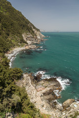 View of ocean, rocky coastline and lush cliff at the Taejongdae Resort Park in Busan, South Korea.