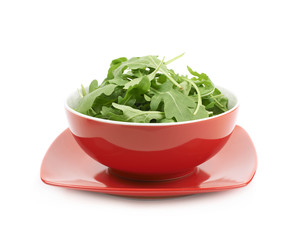Bowl full of rocket salad leaves isolated