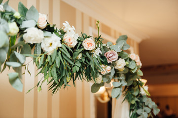 white wedding arch decorated with flower indoor