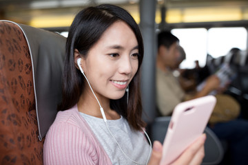 Woman listen to song on mobile phone