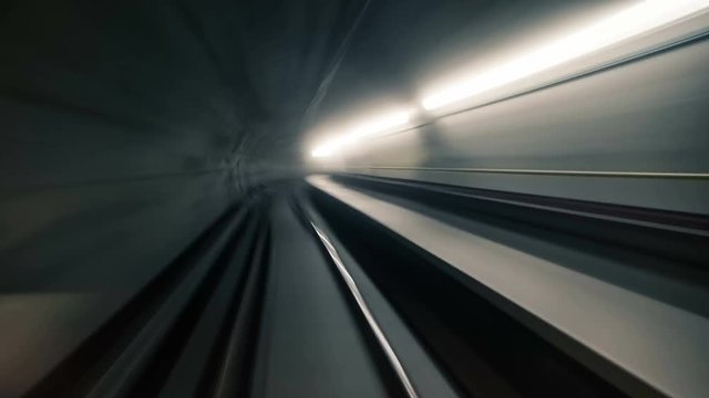 Fast underground train riding in a tunnel of the modern city