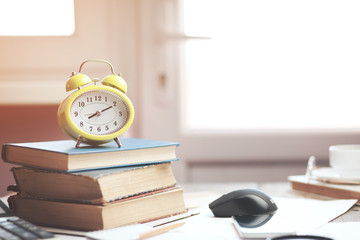 Alarm clock on books