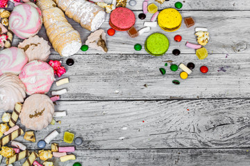 big beautiful pink box with sweets on wooden background