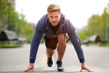 Healthy runner in starting position outside