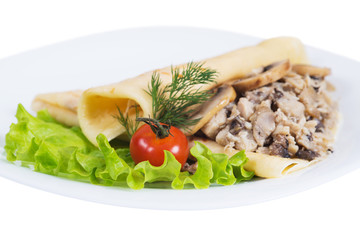 Pancakes with meat and mushrooms on plate