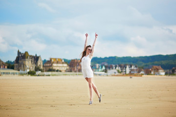 Beautiful young woman enjoying sun on a sand beach