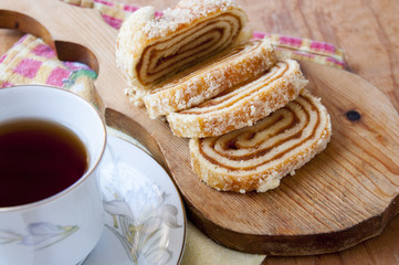 Roll is cut into pieces lying on a cutting board