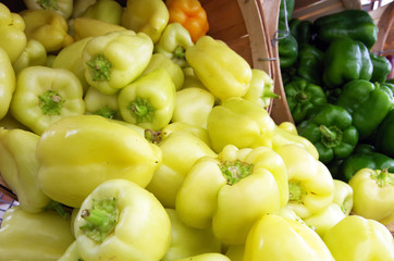 Yellow peppers spill out from baskets on display