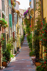alley with entwined houses in Antibes, France - obrazy, fototapety, plakaty