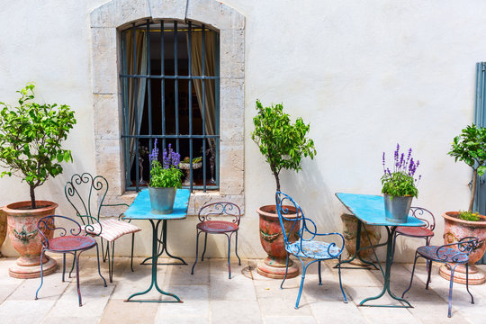picturesque scene with tables and chairs in the Provence