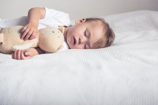 Baby sleep with plush toy 