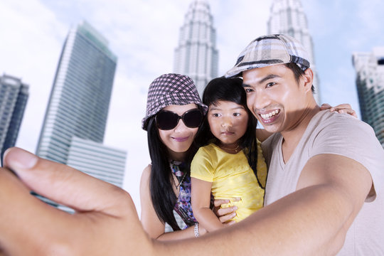 Asian family taking selfie photo