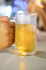Glass of beer against barrels