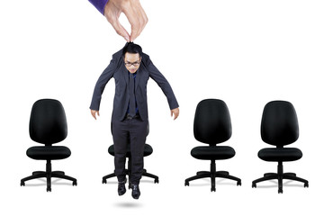 Worker hanging on a hand above chairs